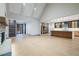 Bright, open living space with a fireplace, light wood floors, and access to a modern kitchen with island at 71 Ramey Rd, Sugar Hill, GA 30518
