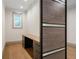 Modern home office with a built-in desk, wood floors, and natural light from a window at 71 Ramey Rd, Sugar Hill, GA 30518