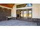Covered patio area featuring brick accents, an outdoor kitchen and a large folding glass doors at 71 Ramey Rd, Sugar Hill, GA 30518