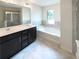 Bathroom featuring double vanity, soaking tub, shower and tiled floors at 7526 Stone Creek Path, Lithonia, GA 30038