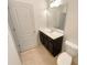 Bathroom featuring vanity with dark cabinets, mirror and tile floor at 7526 Stone Creek Path, Lithonia, GA 30038