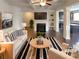 Inviting living room with fireplace, ceiling fan, and an open floor plan at 7526 Stone Creek Path, Lithonia, GA 30038