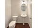 Powder room featuring pedestal sink, oval mirror and tiled floors at 7526 Stone Creek Path, Lithonia, GA 30038