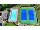 An aerial view of the neighborhood's pool and tennis courts provides recreational opportunities at 10898 Gallier St, Johns Creek, GA 30022