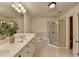 Bright bathroom featuring dual sinks, tiled shower, and soaking tub for a relaxing experience at 10898 Gallier St, Johns Creek, GA 30022