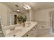 Bright bathroom featuring dual sinks, tiled shower, and soaking tub for a relaxing experience at 10898 Gallier St, Johns Creek, GA 30022