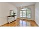 Formal dining room featuring hardwood floors, large window, and elegant chandelier at 10898 Gallier St, Johns Creek, GA 30022