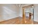 Spacious dining room with hardwood floors open to kitchen and breakfast area at 10898 Gallier St, Johns Creek, GA 30022