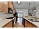 Well-equipped kitchen with stainless steel appliances and ample counter space, open to other living areas at 10898 Gallier St, Johns Creek, GA 30022