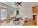 Living area with a ceiling fan, and large windows and doors that lead to a wooden deck at 10898 Gallier St, Johns Creek, GA 30022