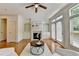 Bright living room with hardwood floors, fireplace, built-in shelving, and access to a deck at 10898 Gallier St, Johns Creek, GA 30022