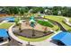 An aerial view of a neighborhood playground with slides and swings surrounded by green space at 10898 Gallier St, Johns Creek, GA 30022