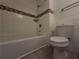 Bathroom with shower-tub and toilet, accented with mosaic tile detail at 237 Sandra Nw Dr, Lilburn, GA 30047