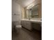 A bathroom featuring a toilet, vanity with mirror, and tiled countertops at 237 Sandra Nw Dr, Lilburn, GA 30047