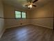 Bedroom with wood flooring, a ceiling fan, and natural light from the window at 237 Sandra Nw Dr, Lilburn, GA 30047