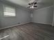 Comfortable bedroom with wood flooring, a window and neutral gray walls at 237 Sandra Nw Dr, Lilburn, GA 30047