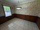 Cozy dining area with tile floors, wood paneling, and a window view at 237 Sandra Nw Dr, Lilburn, GA 30047