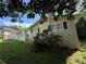 Side view of a well-kept home featuring a landscaped yard and blooming roses at 237 Sandra Nw Dr, Lilburn, GA 30047