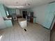 Bright kitchen with an island, stainless steel appliances and white tile floors at 237 Sandra Nw Dr, Lilburn, GA 30047