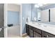Bathroom featuring a white single sink vanity with dark cabinets and view into exercise room with treadmill at 2906 Ansley Manor Ct, Marietta, GA 30062
