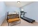 Cozy bedroom with a wooden bed frame, accent table, and exercise treadmill at 2906 Ansley Manor Ct, Marietta, GA 30062