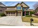 Charming two-story home with a three car garage, a well-manicured lawn, and beautiful curb appeal at 2906 Ansley Manor Ct, Marietta, GA 30062