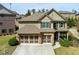 Charming home featuring a well-manicured lawn, attached two-car garage and traditional architectural details at 2906 Ansley Manor Ct, Marietta, GA 30062