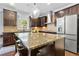 Kitchen with dark cabinets, granite countertops, a kitchen island, and modern appliances at 2906 Ansley Manor Ct, Marietta, GA 30062