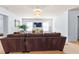 Cozy living room featuring a brown sofa, neutral walls, and a mounted television over a wooden credenza at 2906 Ansley Manor Ct, Marietta, GA 30062
