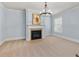 Sitting area with cozy fireplace, carpet flooring, and a large window at 2906 Ansley Manor Ct, Marietta, GA 30062