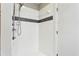 Tiled shower featuring chrome fixtures, a shower head, and a recessed soap dish at 350 Peters Sw St # 6, Atlanta, GA 30313