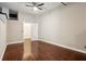 Spacious bedroom featuring hardwood floors, ceiling fan, and a doorway leading to the walk-in closet at 350 Peters Sw St # 6, Atlanta, GA 30313