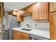 Compact kitchen featuring stainless steel appliances, wood cabinets, and white countertops at 350 Peters Sw St # 6, Atlanta, GA 30313