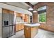 Modern kitchen with stainless steel refrigerator, island gas cooktop, and wooden cabinets at 350 Peters Sw St # 6, Atlanta, GA 30313