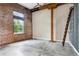Expansive living area featuring exposed brick walls, concrete floors, and a ceiling fan at 350 Peters Sw St # 6, Atlanta, GA 30313
