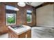 Bright living area showcasing exposed brick, and a kitchen island with a gas cooktop at 350 Peters Sw St # 6, Atlanta, GA 30313
