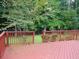 Wooden back deck with a red stain and view of the yard at 3416 N Cook Rd, Powder Springs, GA 30127