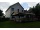 Backyard of a white two story house with a covered patio area, wooden deck, and lush green grass at 3416 N Cook Rd, Powder Springs, GA 30127