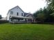 Large backyard with a covered patio area, wooden deck, and lush green grass at 3416 N Cook Rd, Powder Springs, GA 30127