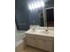 Bathroom with double vanity, large mirror, bathtub, and neutral finishes at 3416 N Cook Rd, Powder Springs, GA 30127