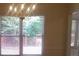 Bright dining room featuring a decorative chandelier and large windows overlooking the backyard at 3416 N Cook Rd, Powder Springs, GA 30127