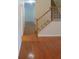 Spacious entryway featuring wood floors and a staircase with white railing and stained wood banister at 3416 N Cook Rd, Powder Springs, GA 30127