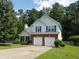 Charming two-story home featuring a well-manicured lawn, mature trees, and an attached two-car garage at 3416 N Cook Rd, Powder Springs, GA 30127