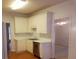 Bright kitchen with white cabinets, stainless steel dishwasher, and open access to the dining area at 3416 N Cook Rd, Powder Springs, GA 30127