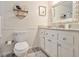 Neat bathroom featuring a toilet, a shelf and a vanity with a granite countertop at 825 Loridans Ne Cir, Atlanta, GA 30342