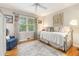 Cozy bedroom with a daybed, a blue chair, hardwood floors, and natural light from the window at 825 Loridans Ne Cir, Atlanta, GA 30342