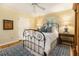 Comfortable bedroom with wood floors, soft lighting, a wrought iron bed, and neutral walls at 825 Loridans Ne Cir, Atlanta, GA 30342