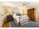 Cozy bedroom with wood floors, ceiling fan, a wrought iron bed, and natural light at 825 Loridans Ne Cir, Atlanta, GA 30342