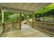 Wooden back deck with railings overlooking a lush wooded backyard at 832 Wyntuck Nw Dr, Kennesaw, GA 30152