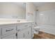 Bathroom with white cabinets, a large mirror, and a shower-tub combination at 832 Wyntuck Nw Dr, Kennesaw, GA 30152